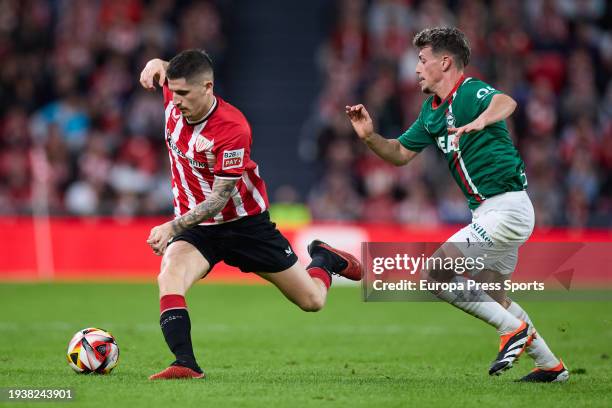 Oihan Sancet of Athletic Club competes for the ball with Antonio Blanco of Deportivo Alaves during the Copa del Rey match between Athletic Club and...