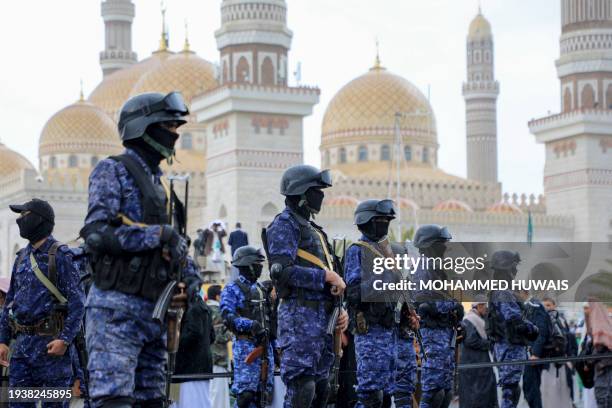 Members of Huthi security forces stand guard during an anti-Israel and anti-US rally in the Huthi-controlled capital Sanaa on January 19 protesting...