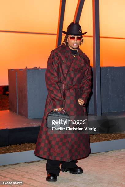 Ozuna is seen wearing rust brown red checkered coat, hat, black bag outside Louis Vuitton during the Menswear Fall/Winter 2024/2025 as part of Paris...