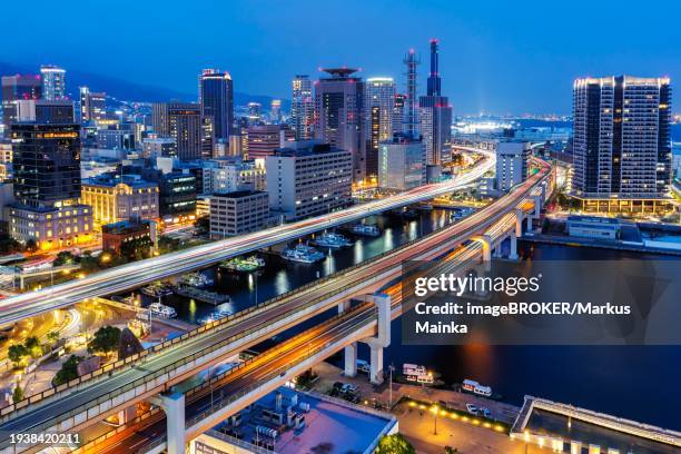 kobe skyline from above with harbour and elevated roads at night in kobe, japan, asia - kobe japan stock pictures, royalty-free photos & images