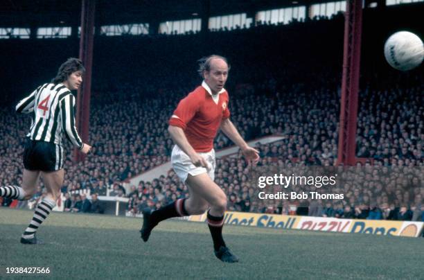 Manchester United footballer Bobby Charlton is watched by Irving Nattrass of Newcastle United during the First Division match between Manchester...