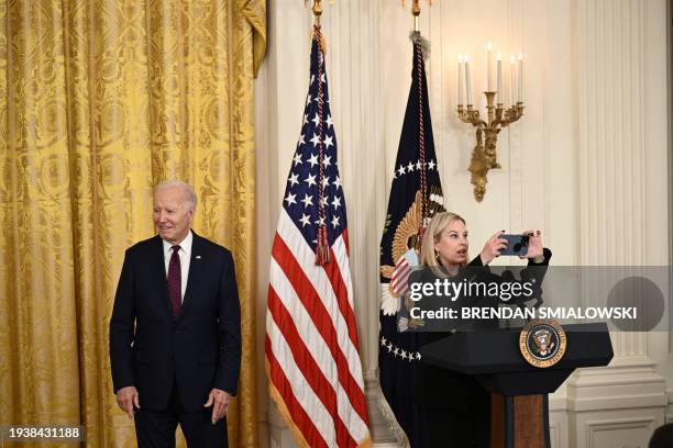 Hillary Shieve, mayor of Reno, Nevada, takes a picture as US President Joe Biden arrives to address mayors attending the US Conference of Mayors...