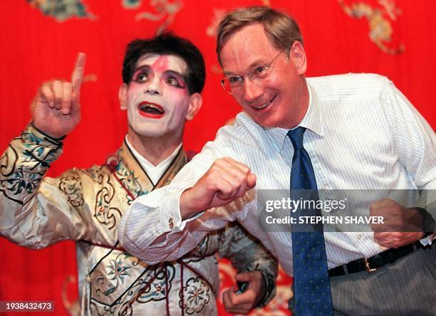 Britain's Duke Richard of Gloucester is shown how to pose as a warrior character 15 July by an expatriate Brit who heads the opera show at a Beijing...