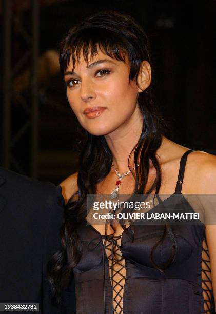 Italian actress Monica Bellucci poses for photographers as she arrives at the palais des festivals to attend the screening of her controversial film...