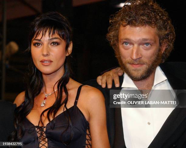 Italian actress Monica Bellucci and French actor Vincent Cassel pose for photographers as they arrive at the palais des festivals to attend the...