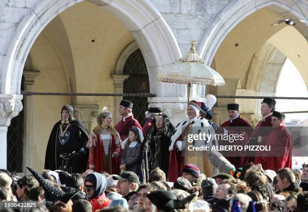 Actors wearing ancient Venetian costumes perform the "Angel Flight" from the San Marco bell tower in Venice 30 January 2005. Venice opens its...