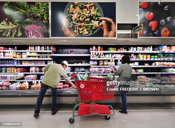 People shop in the food section of a retail store in Rosemead, California, on January 19, 2024. Inflation is mostly declining, but stubbornly high...