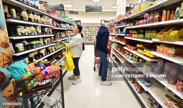 People shop in the food section of a retail store in Rosemead, California, on January 19, 2024. Inflation is mostly declining, but stubbornly high...