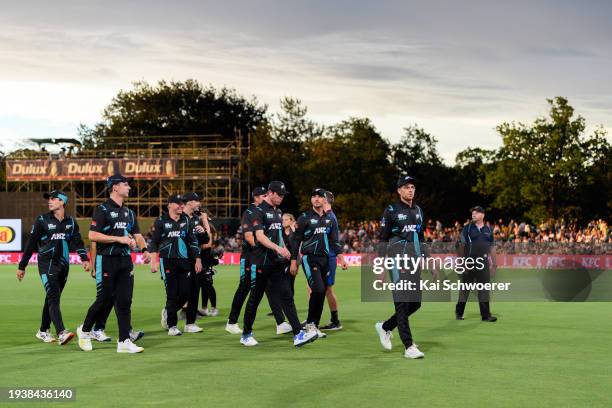 Captain Mitchell Santner of New Zealand and his team mates walk from the ground at the innings break during game four of the Men's T20 series between...