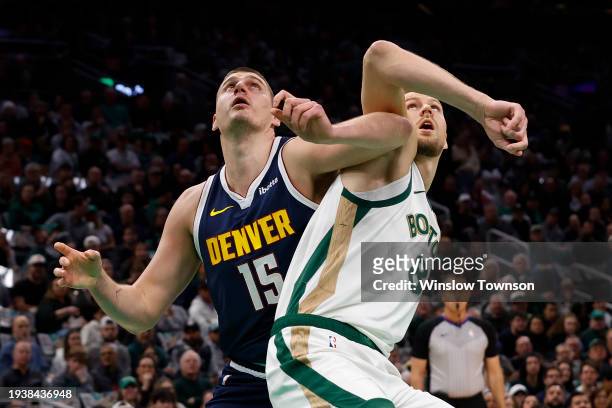 Nikola Jokic of the Denver Nuggets battles Kristaps Porzingis of the Boston Celtics for position under the boards during the first quarter at TD...