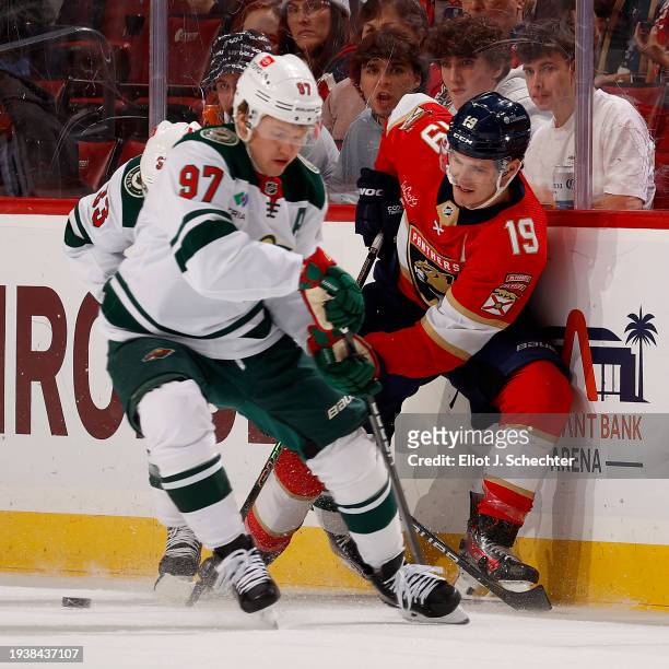 Matthew Tkachuk of the Florida Panthers battles for the puck against Kirill Kaprizov of the Minnesota Wild at the Amerant Bank Arena on January 17,...