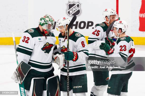 Teammates congratulate Goaltender Filip Gustavsson of the Minnesota Wild after the 6-4 win against the Florida Panthers at the Amerant Bank Arena on...