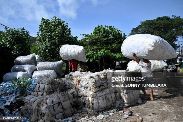 People transport plastic waste that has been selected to be sold to plastic waste collectors in Denpasar on Indonesia resort island of Bali on...