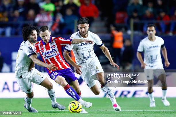 Sebastien Salles-lamonge of Atletico San Luis, struggles for the ball against Cesar Huerta and Lisandro Magallan of Pumas UNAM, during the 2nd round...