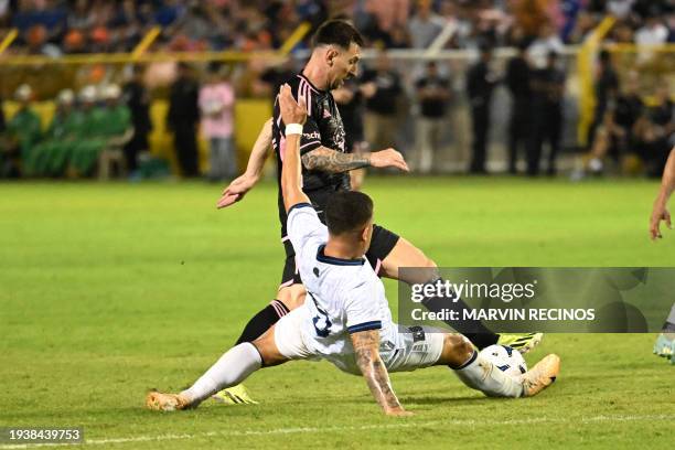 Inter Miami's Argentine forward Lionel Messi and El Salvador's midfielder Melvin Cartagena vie for the ball during the friendly football match...