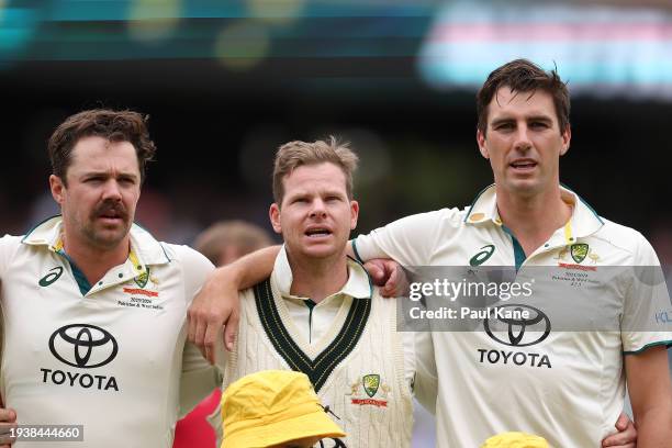 Travis Head, Steve Smith and Pat Cummins of Australia sing the national anthem during the Mens Test match series between Australia and West Indies at...