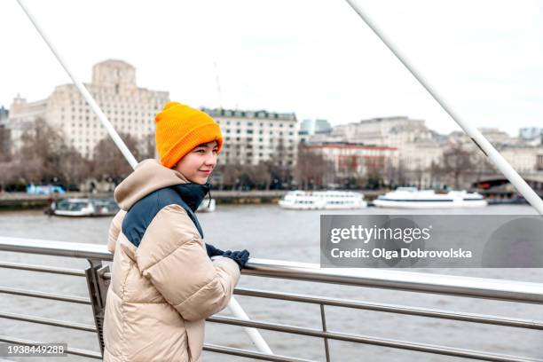 a teenager standing on a bridge and looking away - steel railings stock pictures, royalty-free photos & images