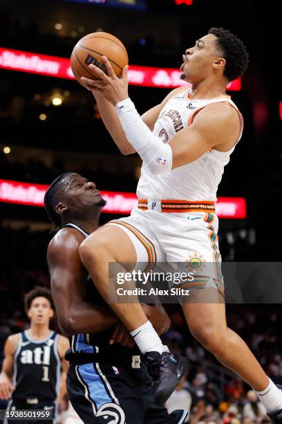 Clint Capela of the Atlanta Hawks draws a fowl from Keldon Johnson of the San Antonio Spurs during the second half at State Farm Arena on January 15,...