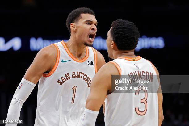 Victor Wembanyama of the San Antonio Spurs celebrates with Keldon Johnson during the second half against the Atlanta Hawks at State Farm Arena on...