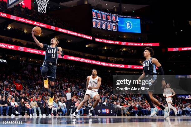 Trae Young of the Atlanta Hawks shoots over Blake Wesley of the San Antonio Spurs during the first half at State Farm Arena on January 15, 2024 in...