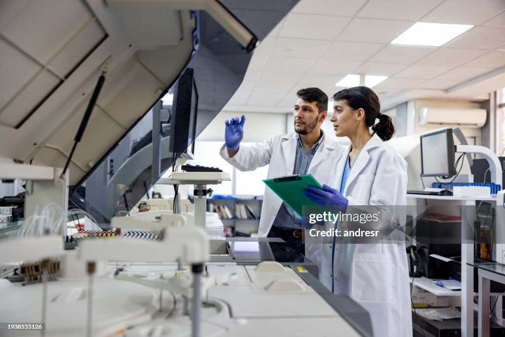Team of scientists working at the laboratory processing blood samples