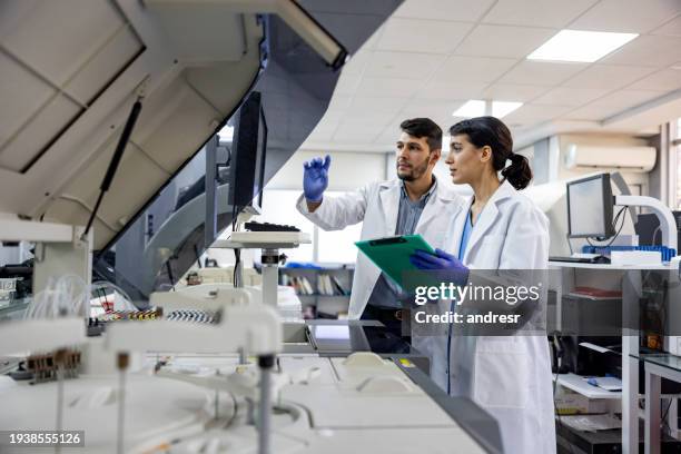 team of scientists working at the laboratory processing blood samples - scientist lab stock pictures, royalty-free photos & images