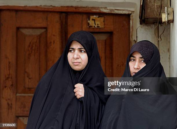 Two Muslims Shias woman wait for Friday prayer to begin at the Kadhimain Mosque April 2003 in Baghdad, Iraq. Most of Iraqi Muslims are either Sunnis...