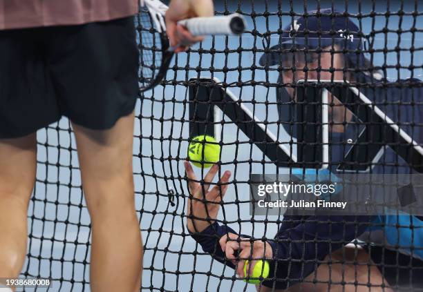Ball kid removes a ball from the net during the round two singles match played between Jannik Sinner of Italy and Jesper de Jong of the Netherlands...
