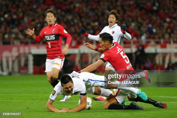 Yuma Suzuki of Kashima Antlers is brought down by Tomoaki Makino of Urawa Red Diamonds in the penalty box resulting in a penalty awarded to Kashima...