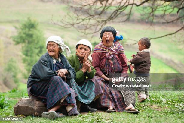 bhutanese locals at an archery match in the himalayans - bhutan stock pictures, royalty-free photos & images