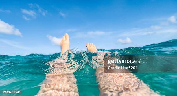 floating in the sea, personal perspective legs underwater - pov or personal perspective or immersion stock pictures, royalty-free photos & images