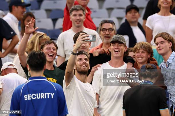 Britain's Cameron Norrie takes a selfie photo with fans as he celebrates after victory against Norway's Casper Ruud in their men's singles match on...