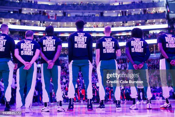 Boston Celtics line up for national anthems ahead of the first half of their NBA game against the Toronto Raptors at Scotiabank Arena on January 15,...