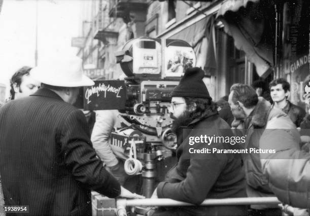 American director Francis Ford Coppola sitting with the camera on the set of his film 'The Godfather; Part II,' 1974.