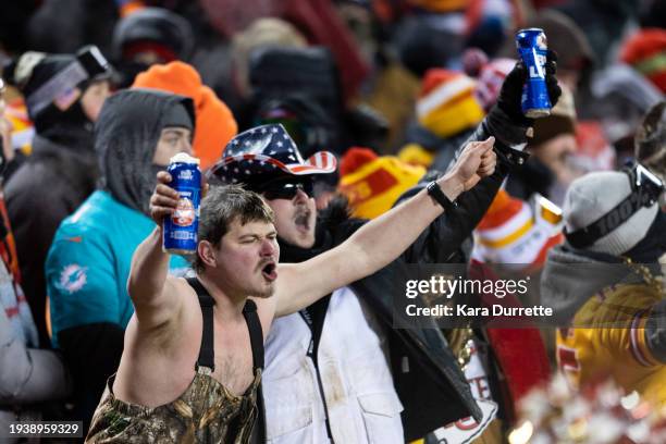 Fans cheer with Bud Light during an NFL wild-card playoff football game between the Miami Dolphins and Kansas City Chiefs at GEHA Field at Arrowhead...