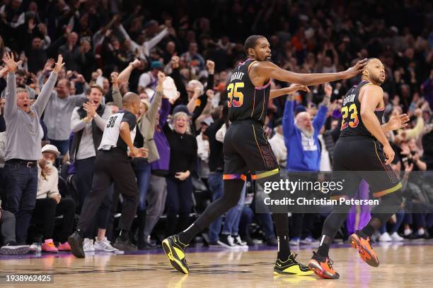 Kevin Durant of the Phoenix Suns celebrates with Eric Gordon after Gordon hit a three-point shot against the Sacramento Kings during the second half...
