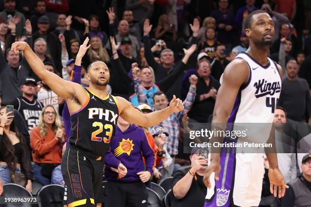 Eric Gordon of the Phoenix Suns reacts to a three-point shot over Harrison Barnes of the Sacramento Kings during the second half of the NBA game at...