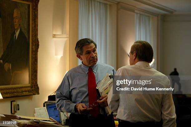 Secretary of Defense Donald Rumsfeld speaks with Deputy Secretary of Defense Paul Wolfowitz in Rumsfeld's office at the Pentagon March 21, 2003 in...