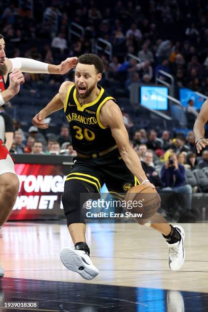 Stephen Curry of the Golden State Warriors is guarded by Jonas Valanciunas of the New Orleans Pelicans at Chase Center on January 10, 2024 in San...