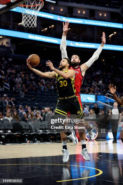 Stephen Curry of the Golden State Warriors is guarded by Jonas Valanciunas of the New Orleans Pelicans at Chase Center on January 10, 2024 in San...