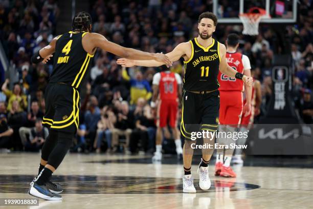 Klay Thompson of the Golden State Warriors high-fives Moses Moody during their game against the New Orleans Pelicans at Chase Center on January 10,...