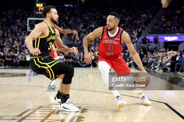 McCollum of the New Orleans Pelicans is guarded by Stephen Curry of the Golden State Warriors at Chase Center on January 10, 2024 in San Francisco,...