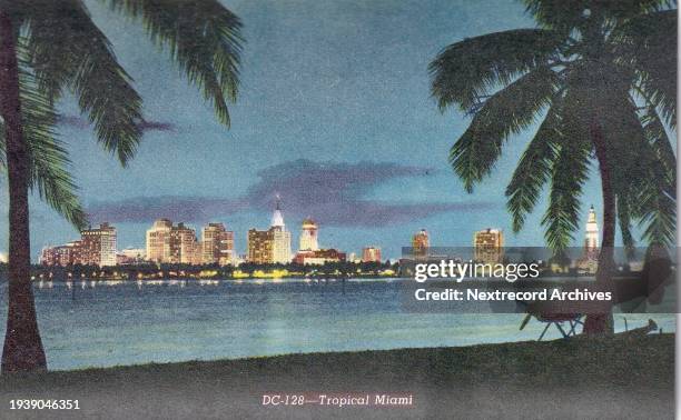 Vintage colorized historic souvenir photo postcard published circa 1945 as part of a series titled, 'Moon Over Miami,' depicting a view of the...