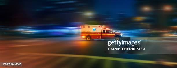 ambulance speeding at night on an urgent call in manhattan new york - motion blur panning action - ambulância imagens e fotografias de stock