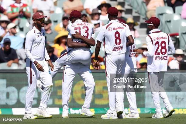 Kirk McKenzie of the West Indies congratulates Shamar Joseph after dismissing Steve Smith of Australia during the Mens Test match series between...