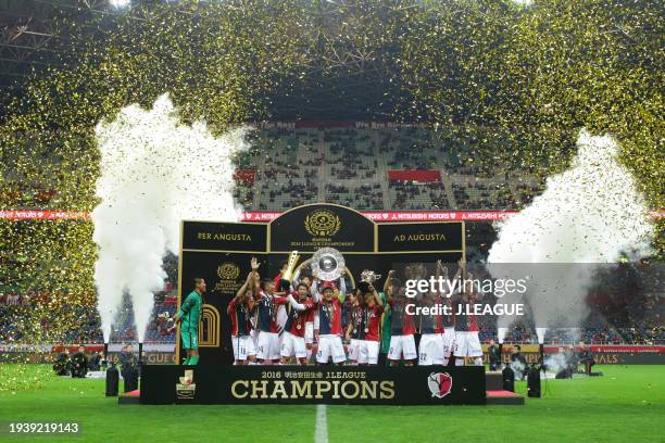 Captain Mitsuo Ogasawara of Kashima Antlers lifts the J.League Champions plaque at the award ceremony following the J.League Championship Final...