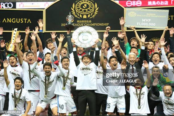 Head coach Masatada Ishii of Kashima Antlers lifts the J.League Champions plaque at the award ceremony following the J.League Championship Final...