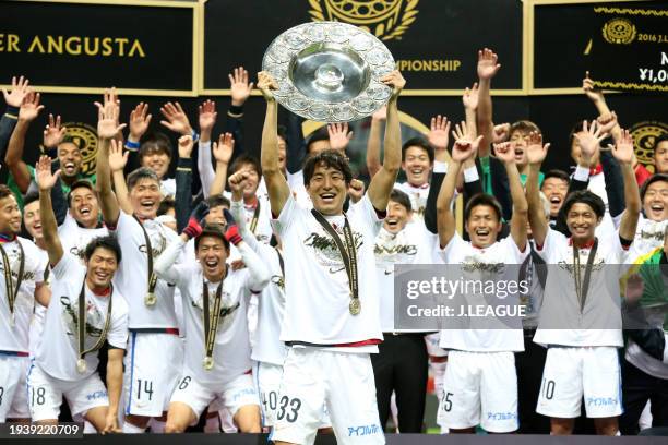 Mu Kanazaki of Kashima Antlers lifts the J.League Champions plaque at the award ceremony following the J.League Championship Final second leg match...