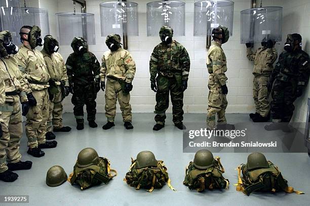 Army soldiers wear gas masks while standing in an chemical school area known as the Hot Zone while they prepare to have the seal of their gas masks...