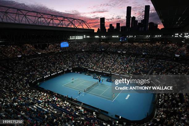 The sunset sky is pictured over Rod Laver Arena during the women's singles match between Poland's Iga Swiatek and Czech Republic's Linda Noskova on...